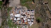 Aerial footage of tornado damage shows homes ripped to shreds, trees flattened