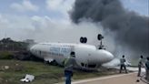 Passenger plane engulfed in flames after flipping over during emergency landing at Somalia airport