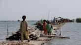 Villagers near Pakistan's largest lake flee homes as 12 more die in floods