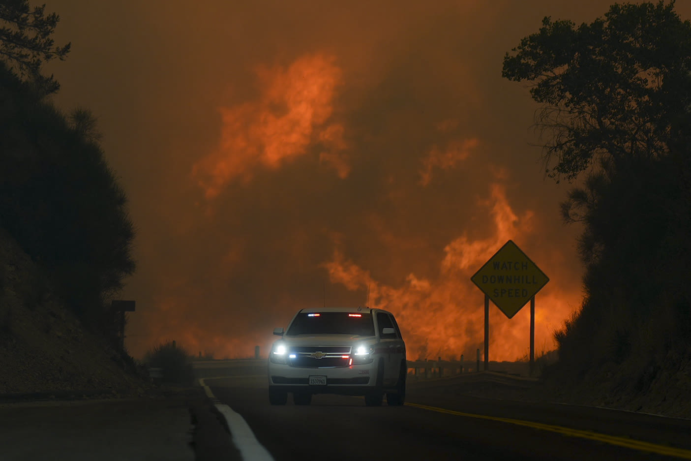 Wildfire east of LA threatens tens of thousands of homes and forces evacuations