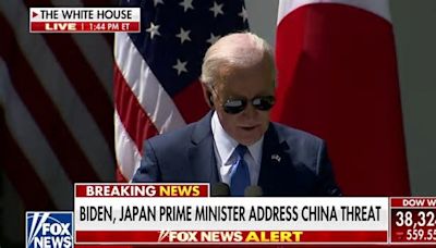 Biden glances down at notes, reporter list during press conference