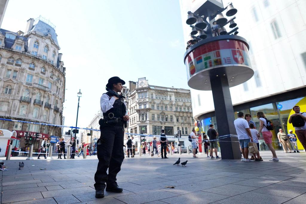 Woman and child, 11, stabbed in busy London square, suspect in custody