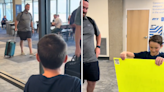 Man greeted at airport by boy holding sign saying "I'm your son"