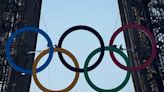 Paris Olympics organizers unveil a display of the five Olympic rings mounted on the Eiffel Tower