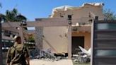 An Israeli soldier checks a house that was hit by a Hezbollah rocket in Kiryat Shmona, northern Israel, near the Lebanon border