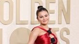 Selena Gomez stuns in red silk dress with torso cut-outs at the Golden Globes