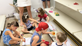 Heartbreaking photo shows children colouring on shop floor as they hide from active shooter in Highland Park