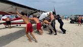Lifeguards rescue pilot after plane towing banner crashes at crowded beach, officials say