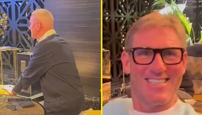 Simon Jordan smirks as he films Jim White on his knees after Scotland exit