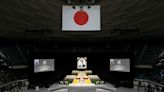 With flowers and a gun salute, Japan bids farewell to divisive Abe