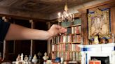 Queen refreshes royal dolls house's tiny library with modern authors to mark centenary