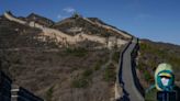 Two people have been accused of using an excavator to destroy part of the Great Wall of China to create a shortcut