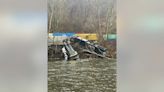 Train derailment leaves cars on riverbank or in water; no injuries, hazardous materials reported