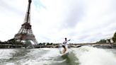 Tahitian surfing champion Kauli Vaast takes victory lap along the Seine