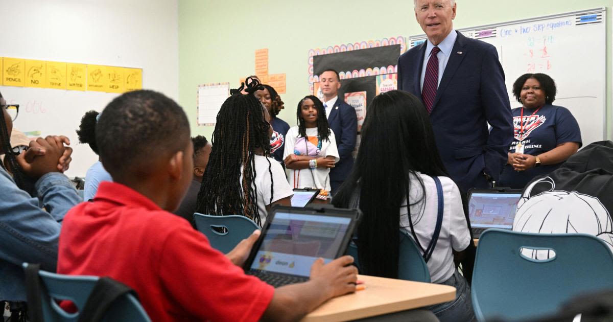 President Joe Biden speaks with students as he and first lady Jill Biden welcome students back to school while visiting a classroom at Eliot-Hine Middle School...