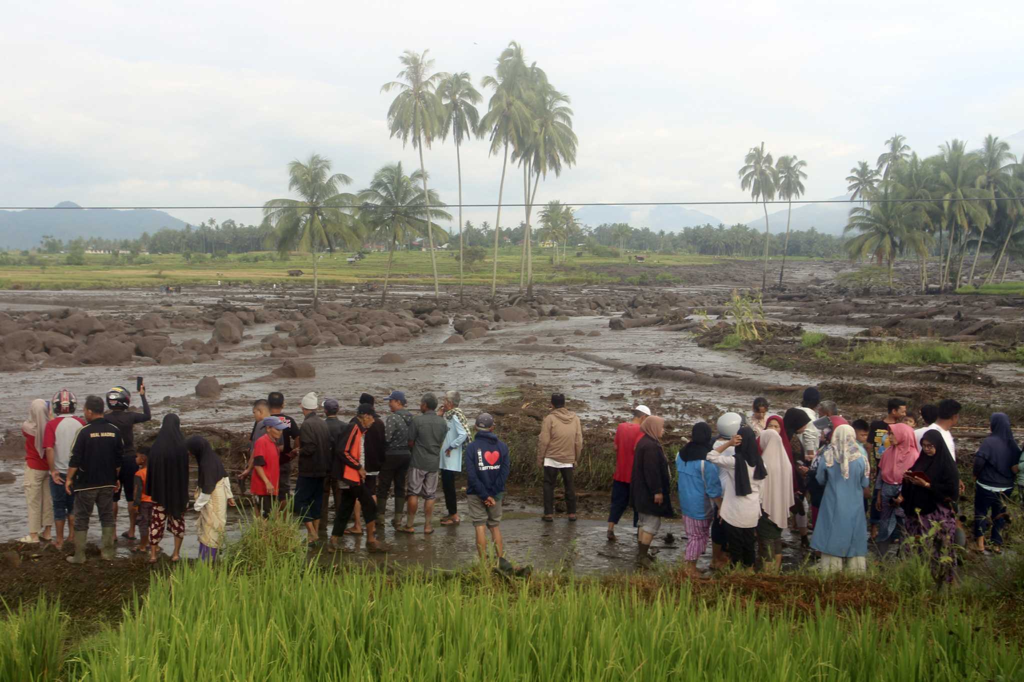 Flash floods and cold lava flow hit Indonesia’s Sumatra island, killing at least 15 people