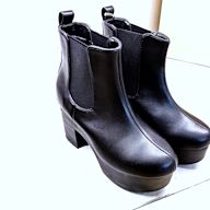 Chelsea boots are a classic style of ankle boots that feature an elastic panel on the side for easy on and off. They are typically made of leather or suede and have a low heel, making them a comfortable and versatile option for everyday wear.