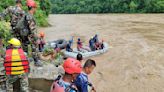 Rescuers in Nepal search for 2 buses with more than 50 people on board that was swept into a river