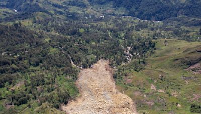 Papua New Guinea's prime minister visits the site of a landslide estimated to have killed hundreds
