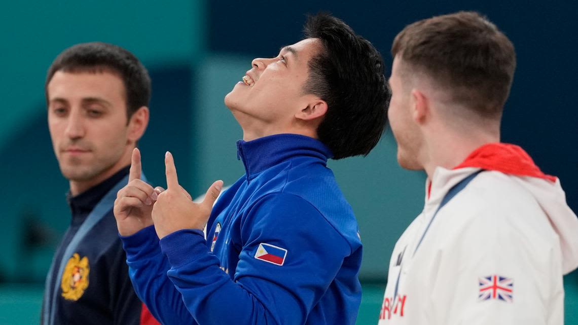 Filipino gymnast who won 2 Olympic golds in Paris gets hero's welcome and free buffets for life