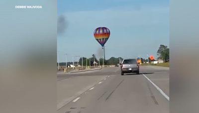 Hot air balloon strikes power lines, burning pilot and 2 passengers