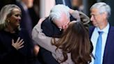 Julian Assange hugs and kisses wife as he arrives in Australia to cheering crowds