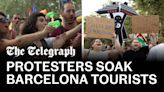 Watch: Protesters soak dining tourists with water pistols