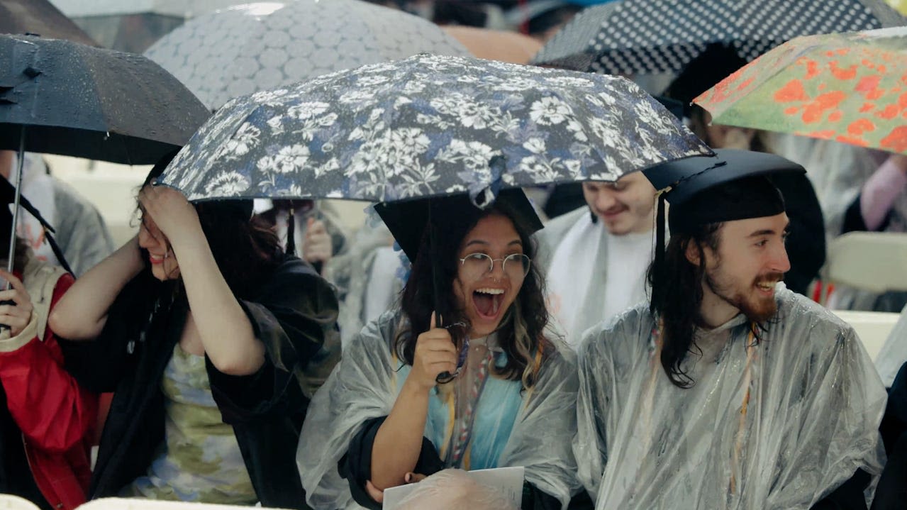 Video captures grads' reaction when billionaire commencement speaker gifts them $1,000 each