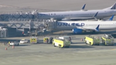 Four taken to hospital after battery catches fire during United flight