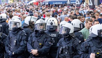 Riot police out in force as England fans take over another German city at Euros