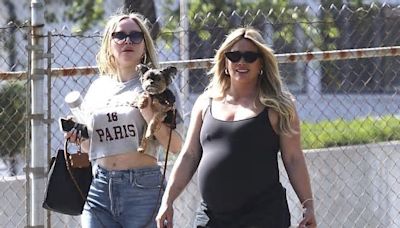 Hilary Duff's STILL pregnant with baby No 4: Actress emerges with big bump after desperately trying natural remedies to bring on labor and banning fans from asking about birth