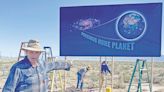 A new galaxy adorns Highway 17 with a 'Precious Home Planet' billboard