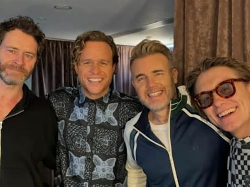 Olly Murs confirms he is back touring with Take That as he poses backstage in Scotland after cancelling a show: 'Lads don't worry I'm back for good!'