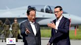 South Korean and Polish leaders visit an air base in eastern Poland, discuss defense and energy ties