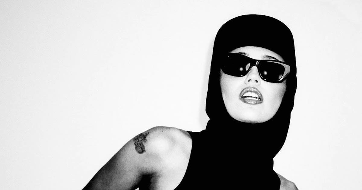 Miley Cyrus Goes Full Grace Jones In a Hooded Boydsuit & Latex Skirt