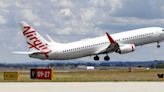 Australian police arrest a man accused of running naked through an airliner