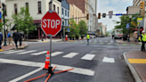 Temporary stop signs in place at a busy intersection