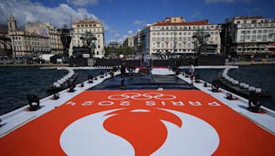 The Olympic torch is being welcomed in French port city of Marseille with fanfare and high security