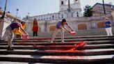 Women's rights activists cover Rome's Spanish Steps in red paint