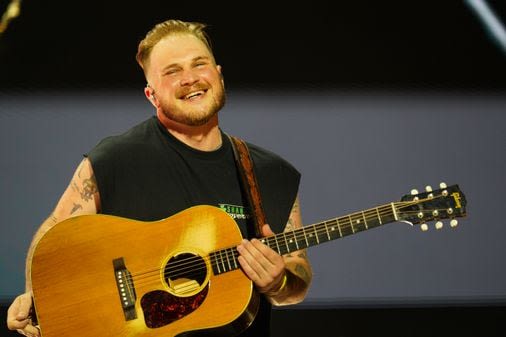 Thunderstorms couldn’t stop Zach Bryan from bringing the electricity to Gillette Stadium - The Boston Globe