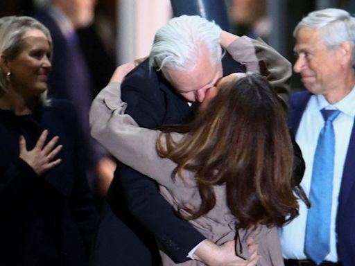 Julian Assange hugs and kisses wife as he arrives in Australia to cheering crowds