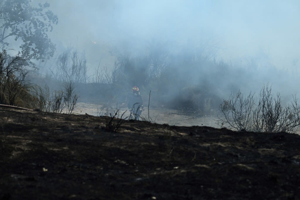 Wildfires create smoke clouds that hold heat and warm the earth, researchers say