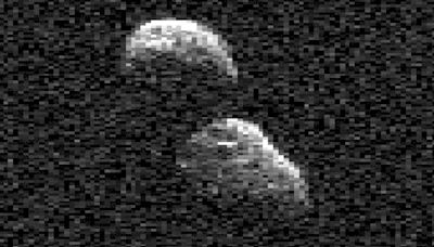 Snowman-shaped object hurdling past Earth; What is it?