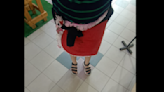 Woman denied entry into Malaysian police station, uses cushion cover to extend skirt