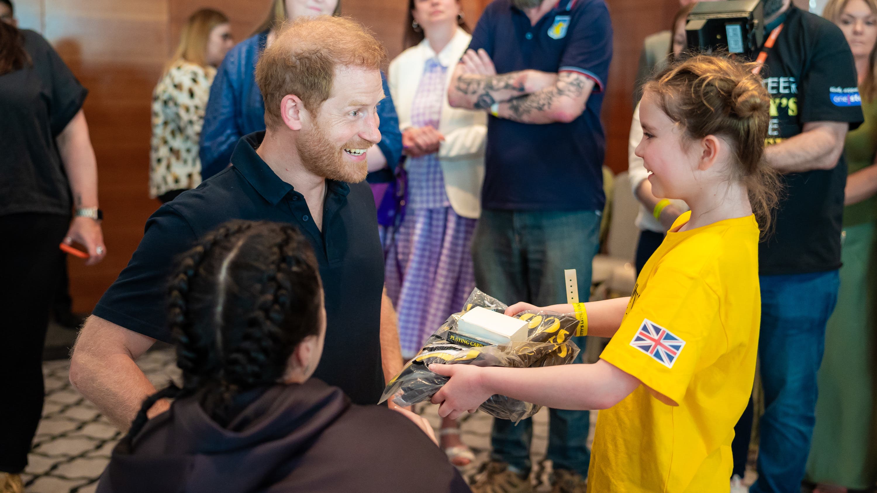 Harry pays surprise visit to charity event for bereaved military children