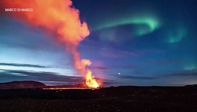 Northern lights shine during volcano eruption