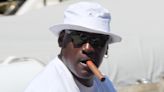 Michael Jordan puffs on a cigar while he and his wife enjoy a stroll