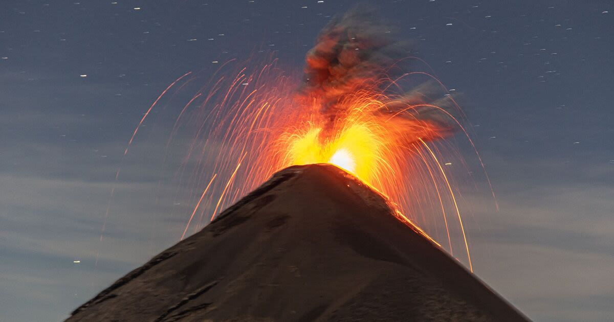 Moment lightning strikes erupting volcano as it spews ash and lava into the air