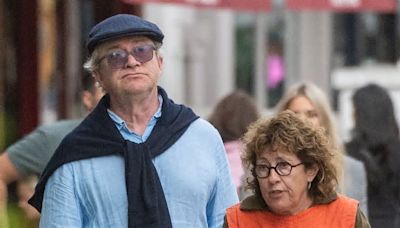 Harry Enfield, 62, heads out for lunch with pal Jo Green and his two dogs in north London before enjoying an afternoon stroll