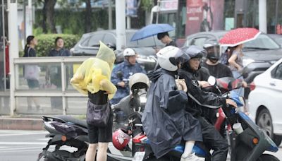 台北午後陣雨 機車騎士把握空檔穿雨衣 (圖)